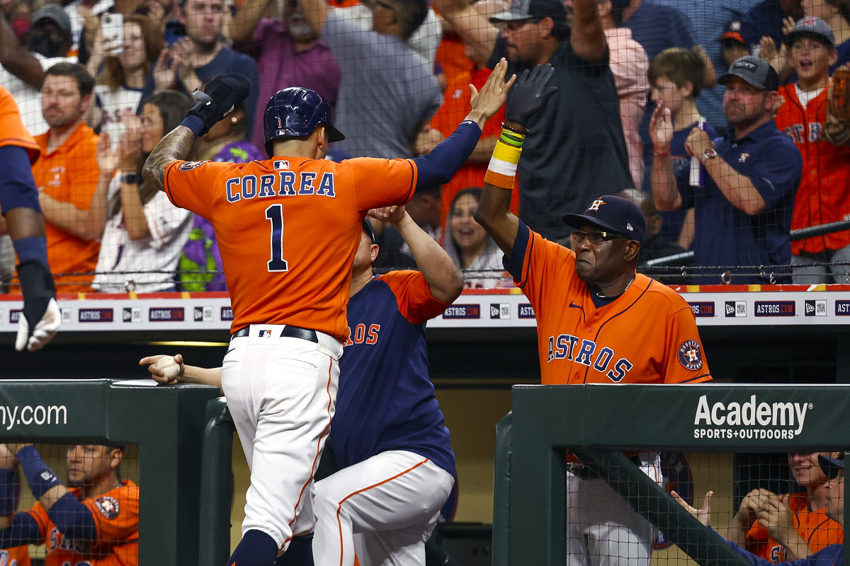 Dusty Baker high fives shortstop Carlos Correa